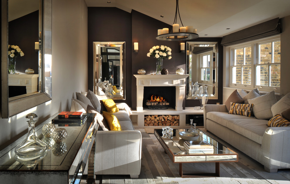Traditional formal and grey and brown living room in London with beige walls, a standard fireplace and a stone fireplace surround.