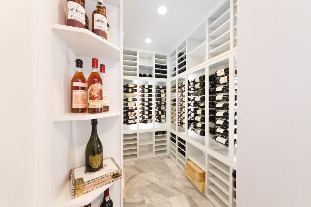 Photo of a mid-sized contemporary wine cellar in New York with marble floors and storage racks.