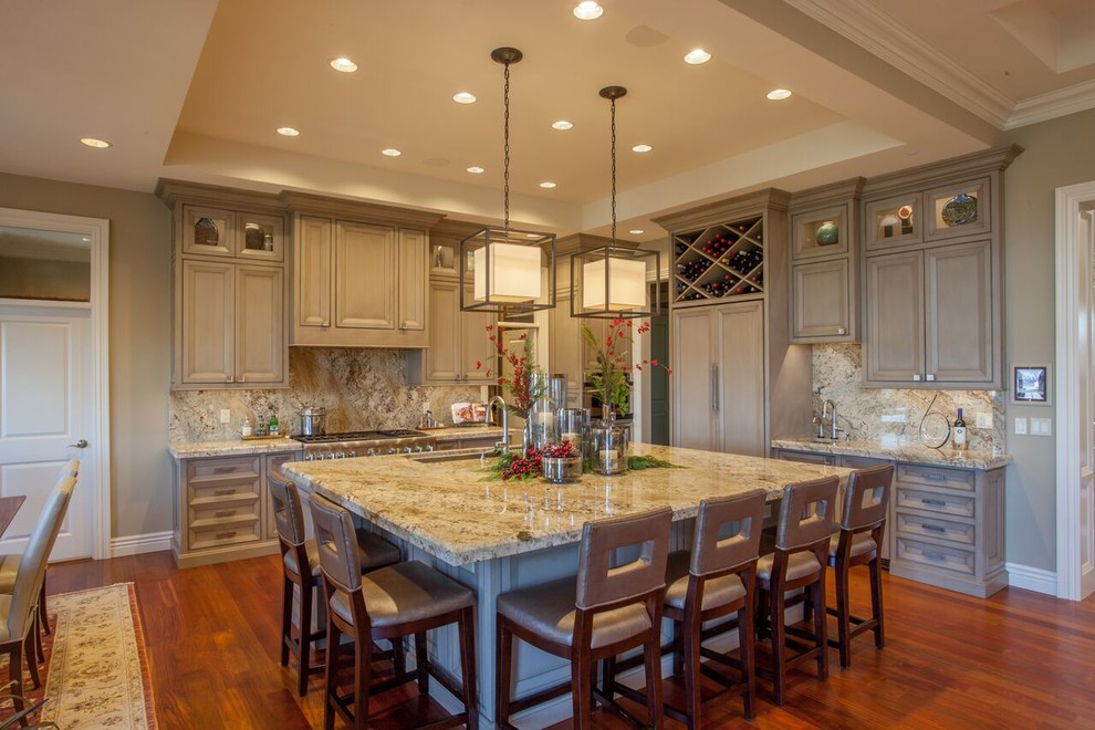 Open concept kitchen - large transitional medium tone wood floor open concept kitchen idea with recessed-panel cabinets, gray cabinets, granite countertops, beige backsplash, paneled appliances and an island