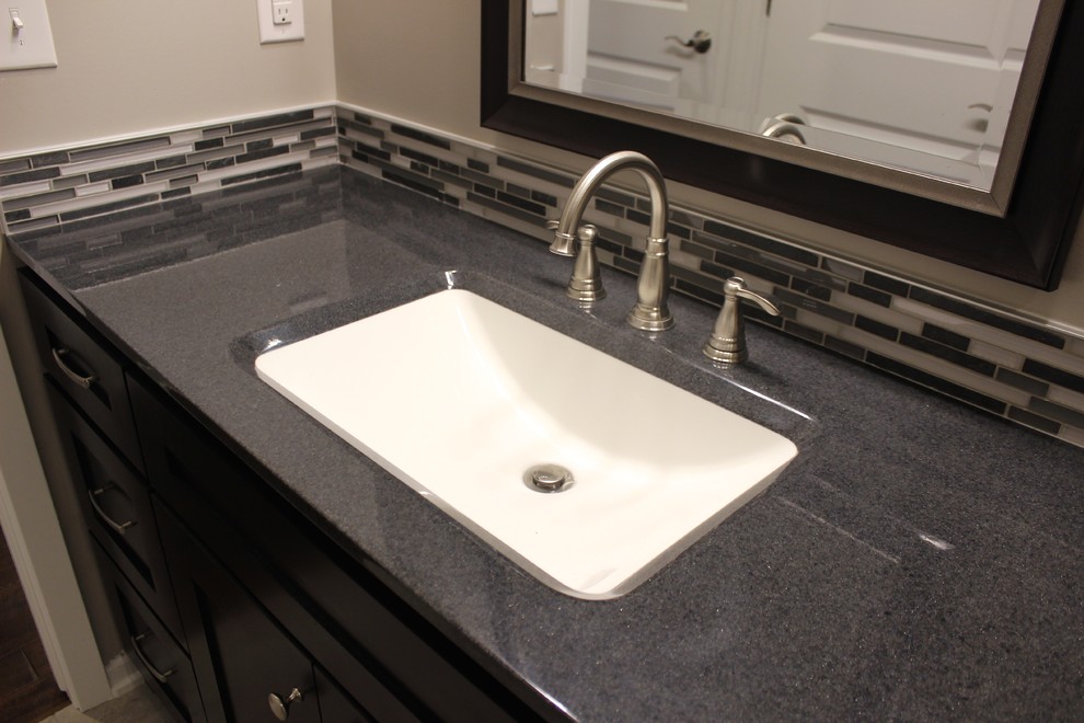 Bathroom - transitional gray tile and mosaic tile bathroom idea with shaker cabinets, dark wood cabinets and onyx countertops