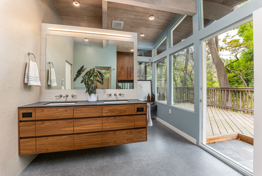 Photo of a mid-sized contemporary master bathroom in Los Angeles with flat-panel cabinets, an open shower, beige tile, porcelain tile, blue walls, porcelain floors, an undermount sink, engineered quartz benchtops, grey floor, a hinged shower door, grey benchtops, a shower seat, a double vanity, a floating vanity and exposed beam.