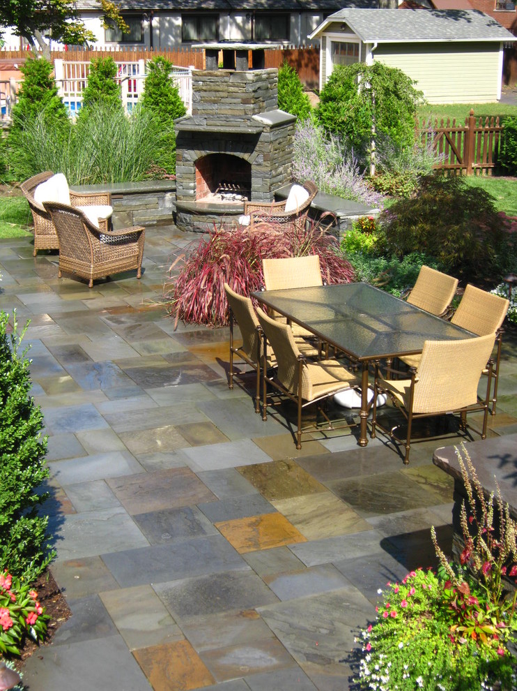 Large traditional backyard patio in New York with tile, no cover and a fire feature.