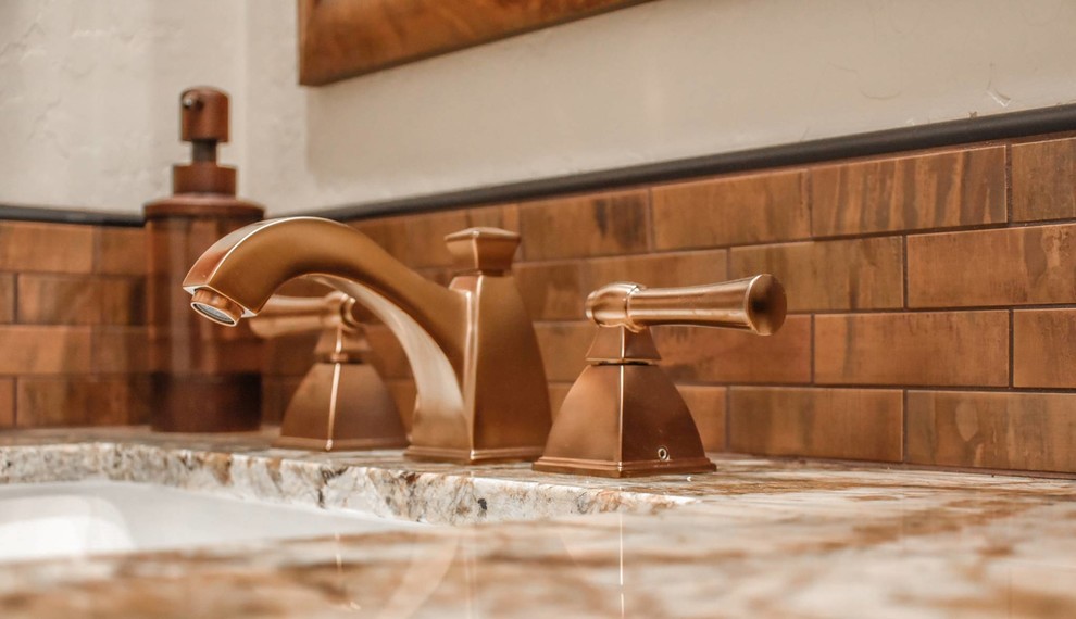 Brown tile and metal tile bathroom photo in Phoenix with beige walls and an integrated sink