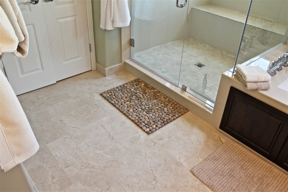 This is an example of a large contemporary master bathroom in Orange County with a drop-in sink, raised-panel cabinets, dark wood cabinets, engineered quartz benchtops, a drop-in tub, a corner shower, a bidet, beige tile, porcelain tile, multi-coloured walls and porcelain floors.