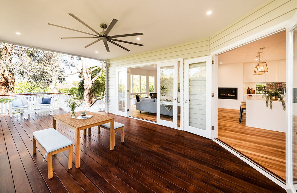 This is an example of a large contemporary backyard patio in Melbourne with decking and a roof extension.