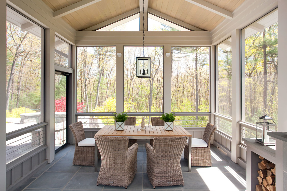 Photo of a traditional sunroom in Boston with slate floors, a standard ceiling and grey floor.