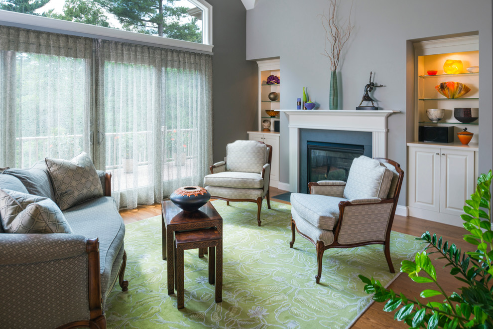 This is an example of a traditional living room in Boston with grey walls.