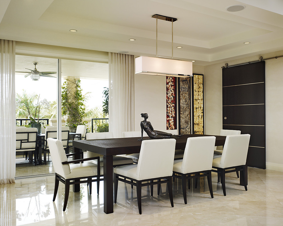 This is an example of a mid-sized contemporary dining room in Miami with white walls, marble floors and no fireplace.
