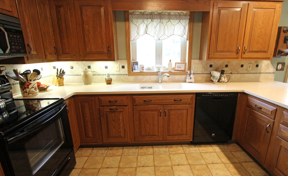 This is an example of a mid-sized u-shaped eat-in kitchen in Cleveland with limestone splashback.