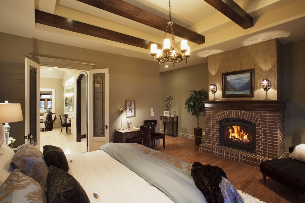 This is an example of a traditional bedroom in Calgary with a brick fireplace surround and a standard fireplace.