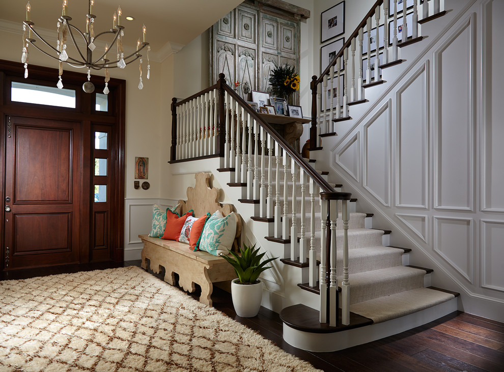 Inspiration for a beach style entryway in Miami with beige walls, dark hardwood floors, a single front door, a dark wood front door and brown floor.