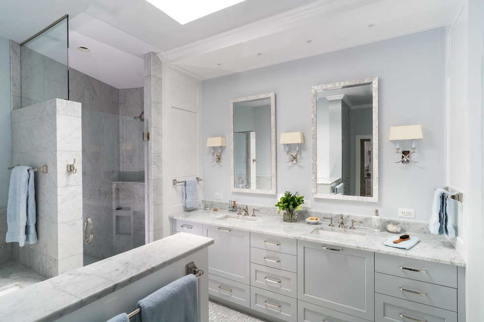Photo of a mid-sized transitional master bathroom in Austin with shaker cabinets, grey cabinets, a corner shower, gray tile, marble, grey walls, an undermount sink, marble benchtops, grey floor, a hinged shower door and grey benchtops.