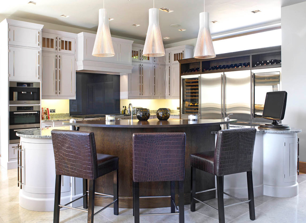 Large contemporary eat-in kitchen in Other with a drop-in sink, beige cabinets and granite benchtops.