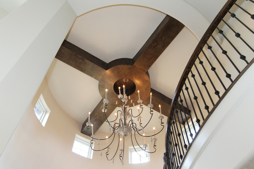 Large traditional wood spiral staircase in Houston with wood risers.