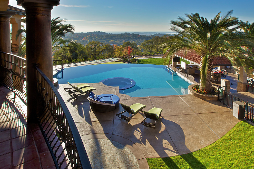 Design ideas for a tropical backyard infinity pool in Sacramento.