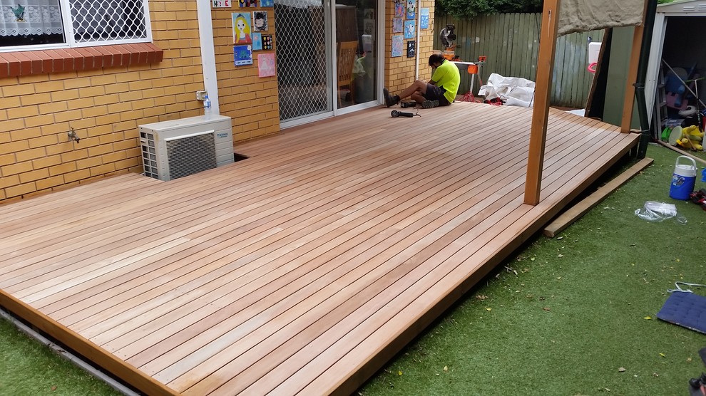 This is an example of a small modern backyard deck in Sydney.