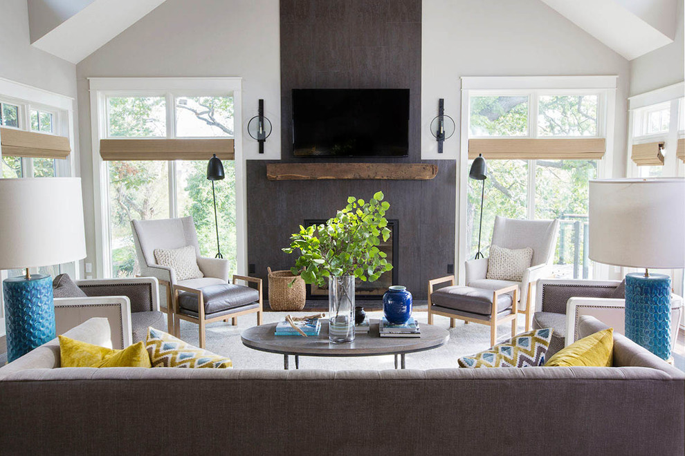 Design ideas for a mid-sized transitional open concept living room in Other with grey walls, medium hardwood floors, a standard fireplace, a stone fireplace surround and a wall-mounted tv.