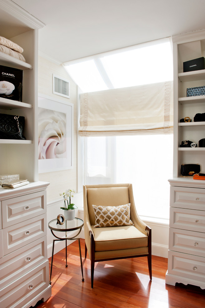 This is an example of a mid-sized transitional women's walk-in wardrobe in Boston with raised-panel cabinets, white cabinets, dark hardwood floors and brown floor.