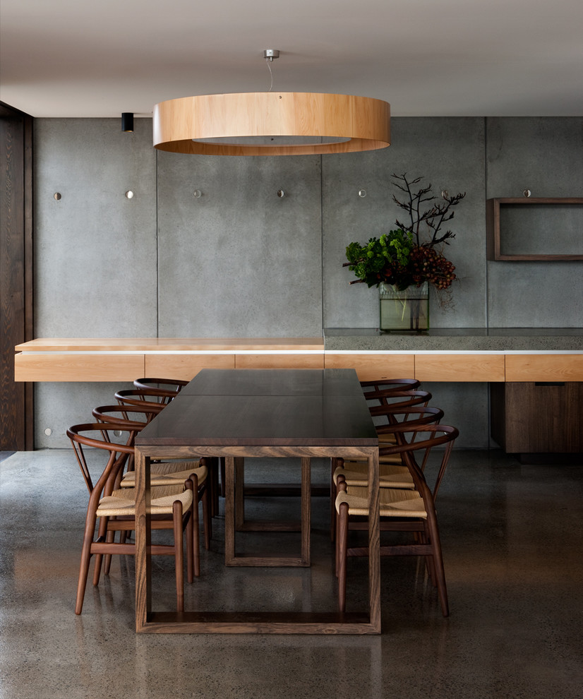 Modern dining room in Hobart with concrete floors.