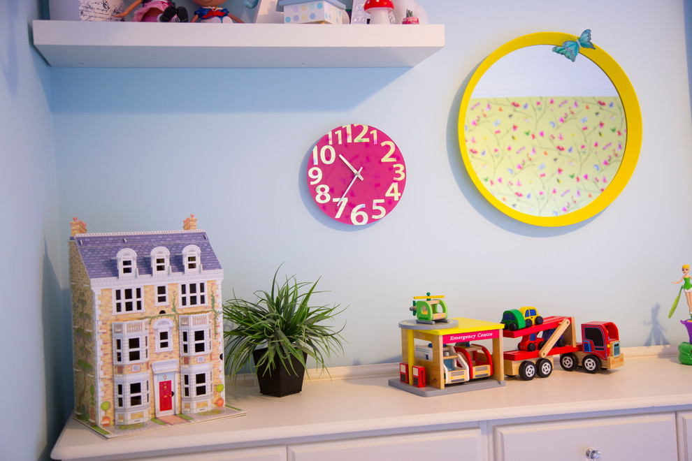 Design ideas for a small modern bedroom in Cardiff with blue walls and light hardwood flooring.