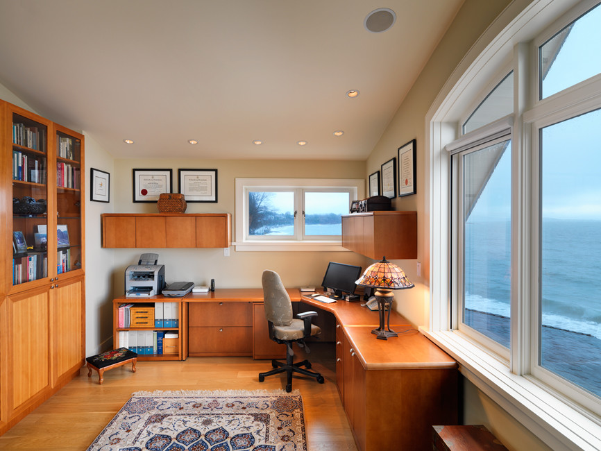 Transitional freestanding desk light wood floor home office photo with beige walls