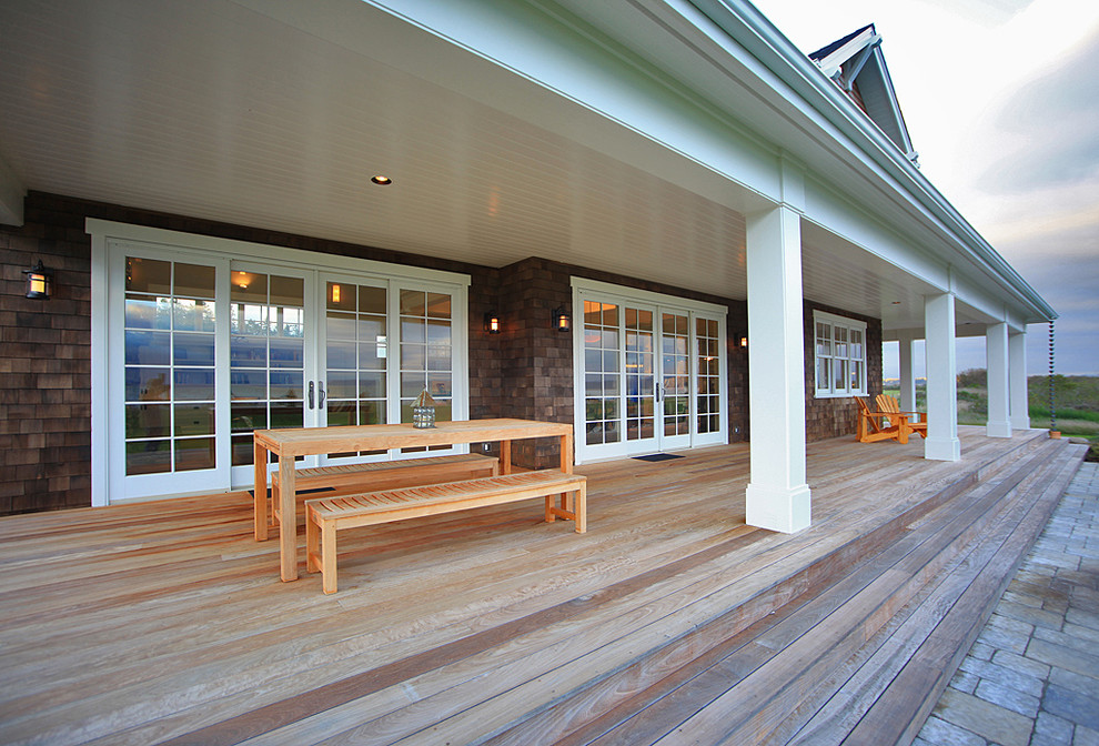 Design ideas for a mid-sized country side yard verandah in Seattle with decking and a roof extension.