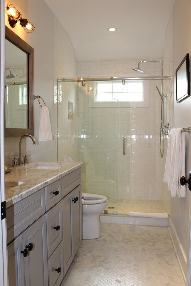Transitional master subway tile marble floor alcove shower photo with beaded inset cabinets, gray cabinets, a two-piece toilet, gray walls, an undermount sink and marble countertops