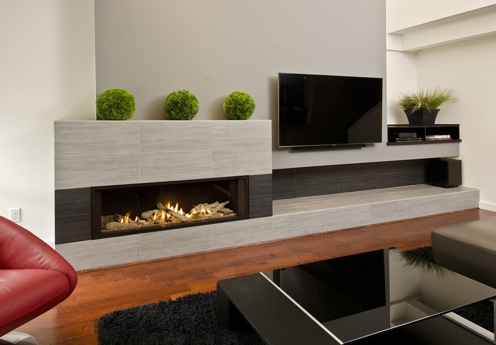 Photo of a large modern open concept living room in Portland with grey walls, dark hardwood floors, a ribbon fireplace, a tile fireplace surround and a wall-mounted tv.