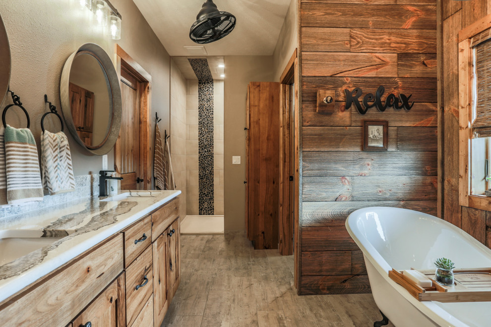 Mid-sized mountain style master travertine tile porcelain tile and gray floor claw-foot bathtub photo in Omaha with recessed-panel cabinets, beige walls, an undermount sink, onyx countertops and white countertops