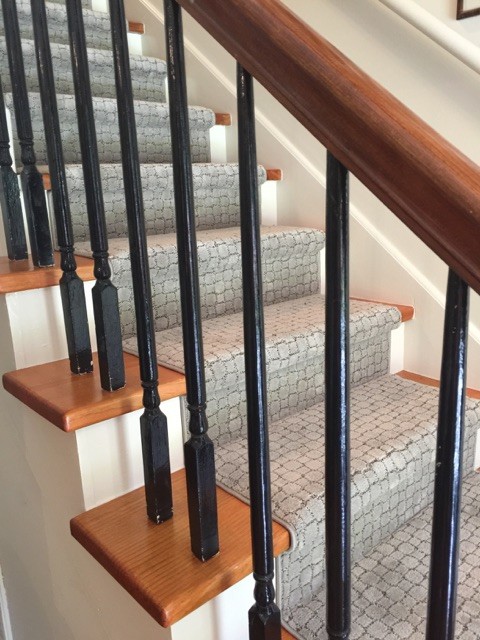 A pretty new runner for a newly refinished staircase. transitional-staircase