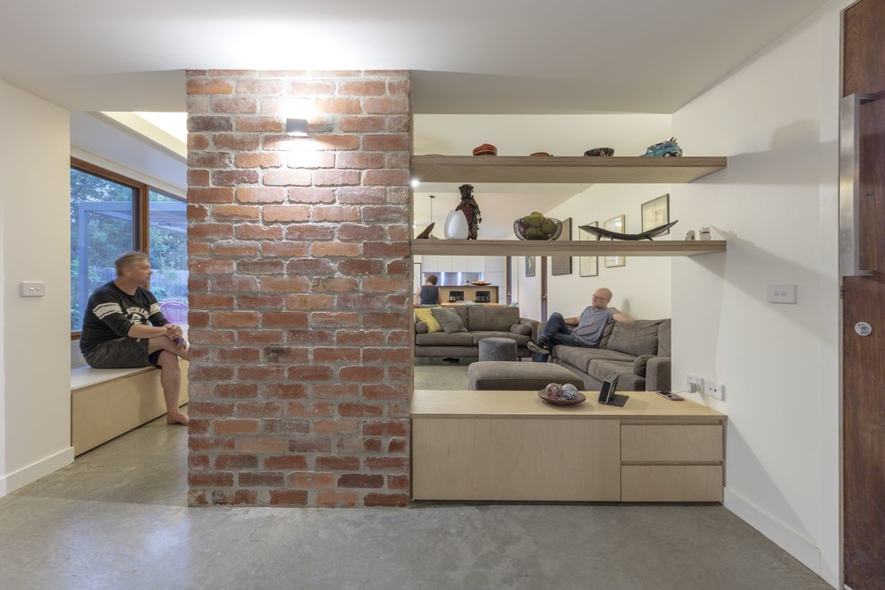 Photo of a small contemporary vestibule in Canberra - Queanbeyan with white walls, concrete floors, a single front door, a glass front door and grey floor.
