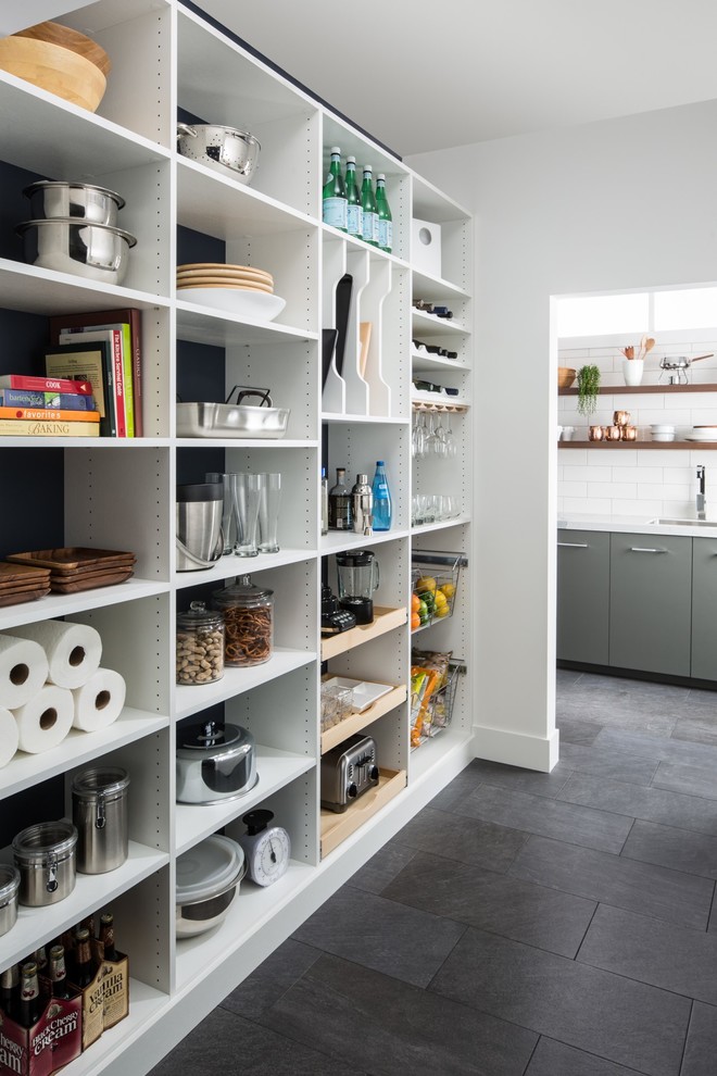Mid-sized contemporary kitchen pantry in Chicago with flat-panel cabinets, white cabinets, marble benchtops, white splashback, subway tile splashback, slate floors, no island and grey floor.