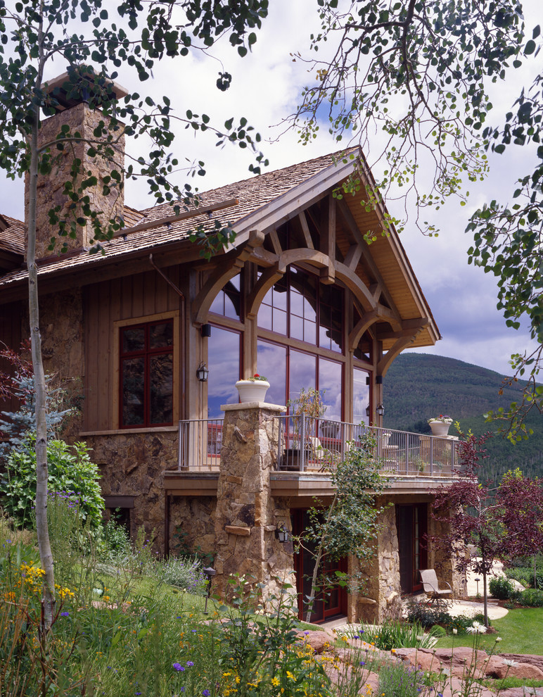 Photo of a large traditional three-storey beige exterior in Denver with wood siding and a gable roof.