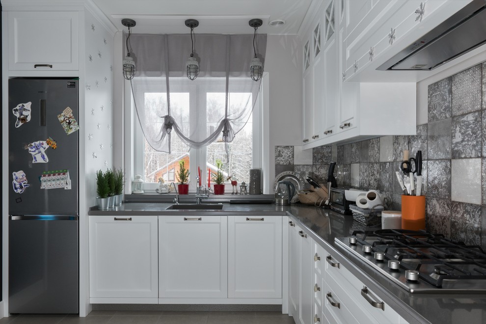 This is an example of a large scandinavian u-shaped eat-in kitchen in Moscow with an integrated sink, recessed-panel cabinets, white cabinets, solid surface benchtops, grey splashback, ceramic splashback, stainless steel appliances, ceramic floors, no island, grey floor and grey benchtop.