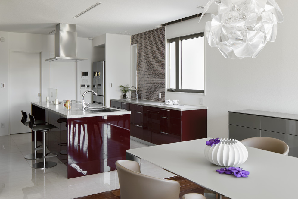 This is an example of a large contemporary single-wall open plan kitchen in Other with a double-bowl sink, beaded inset cabinets, purple cabinets, quartz benchtops, brown splashback, ceramic splashback, stainless steel appliances, ceramic floors, with island and beige floor.