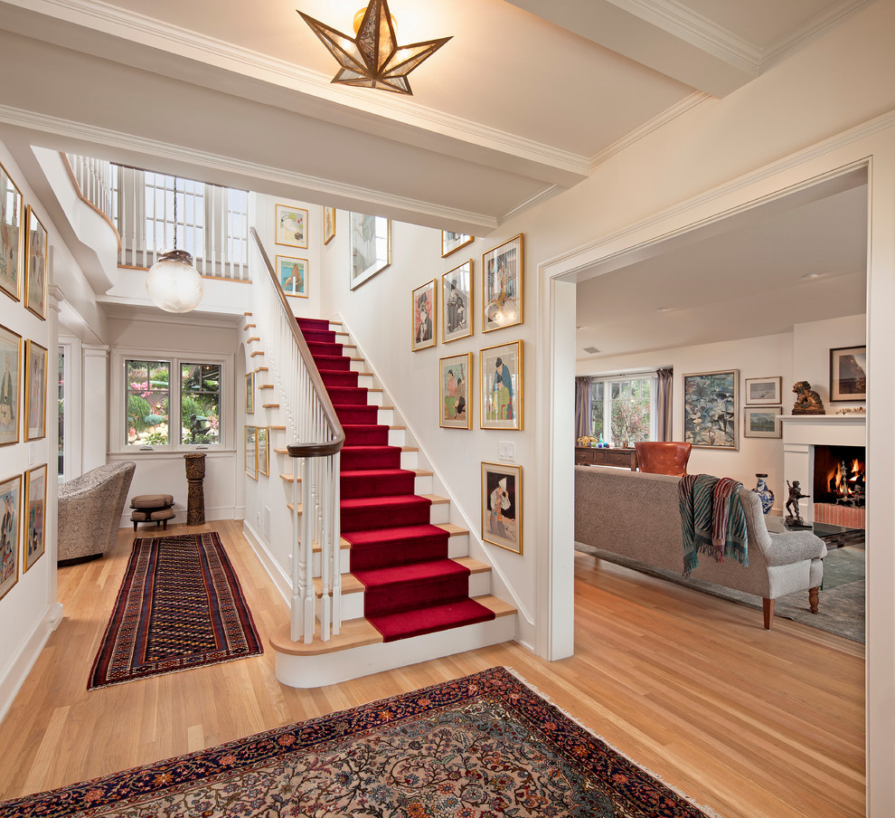 Traditional foyer in Santa Barbara with white walls and light hardwood floors.