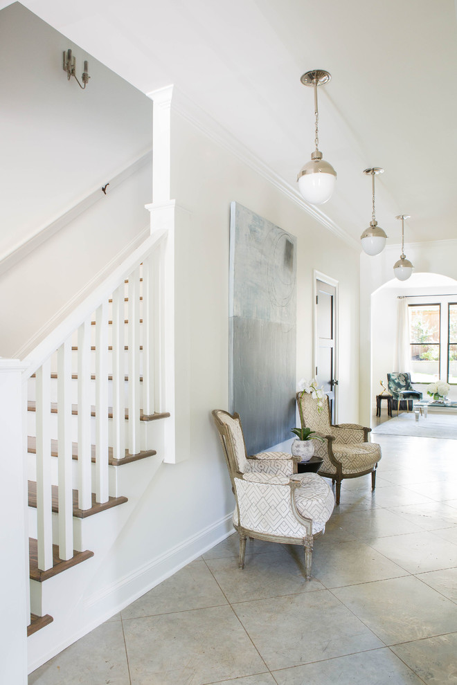 Example of a mid-sized transitional concrete floor and beige floor entry hall design with white walls