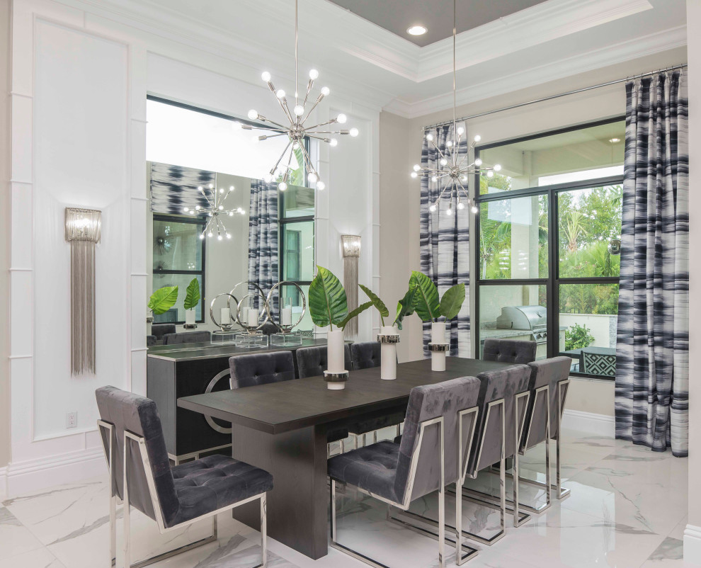 Photo of a transitional dining room in Miami with white walls, porcelain floors and white floor.