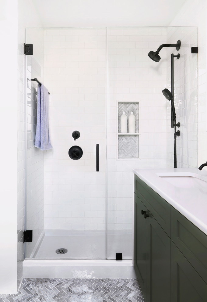 Photo of a medium sized modern bathroom with shaker cabinets, green cabinets, a built in vanity unit, white tiles, metro tiles, white walls, a submerged sink, a hinged door, white worktops, a single sink, ceramic flooring and grey floors.