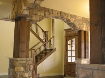 Foyer - mid-sized rustic dark wood floor foyer idea in Boise with yellow walls and a medium wood front door