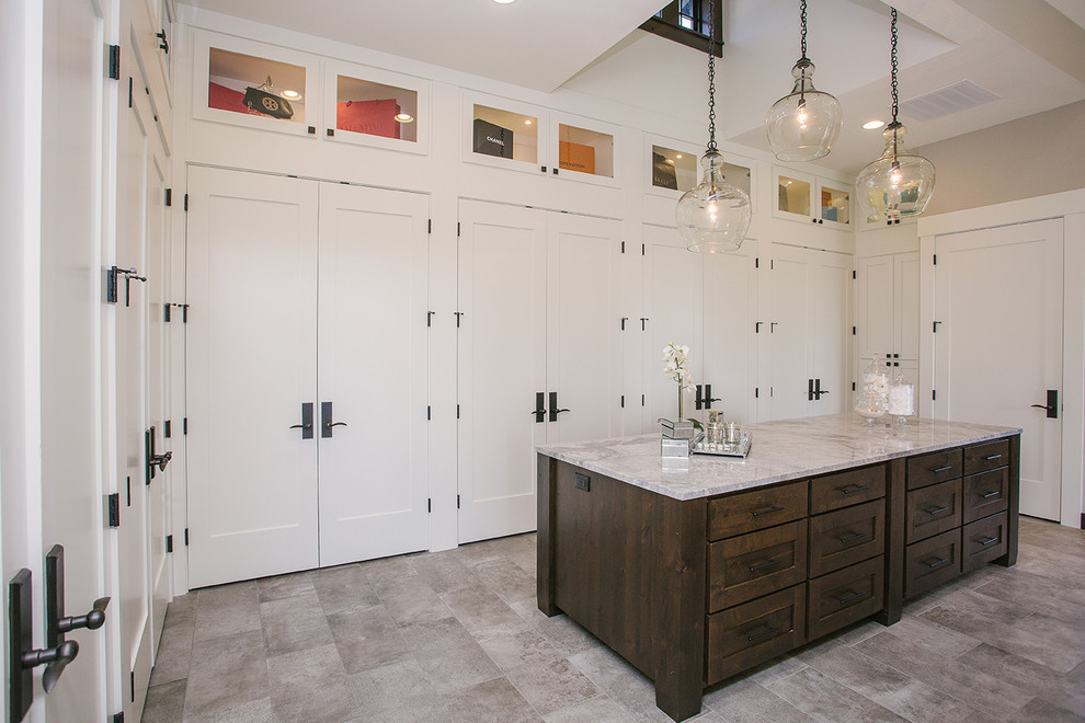 Design ideas for a large transitional gender-neutral walk-in wardrobe in Portland with white cabinets, grey floor, shaker cabinets and porcelain floors.