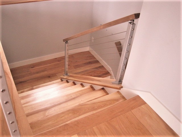 Traditional staircase in Other with cable railing.