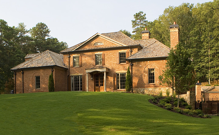 Inspiration for a large traditional two-storey brick red house exterior in Atlanta with a hip roof and a shingle roof.