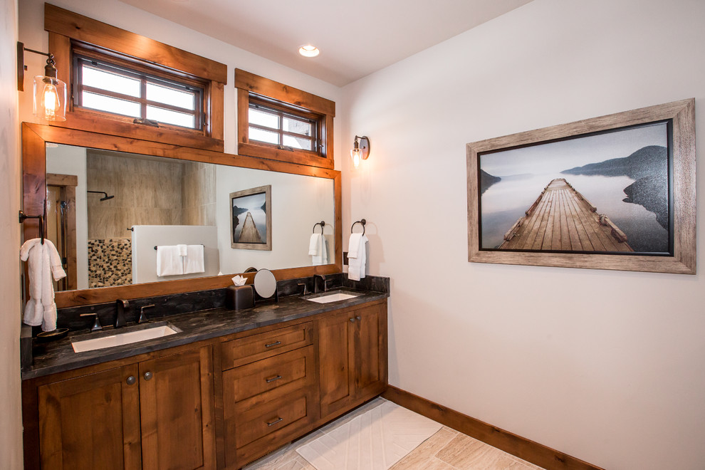 Mid-sized country master bathroom in Other with shaker cabinets, medium wood cabinets, beige tile, ceramic tile, beige walls, ceramic floors, an undermount sink, granite benchtops, an alcove shower, beige floor, an open shower and black benchtops.