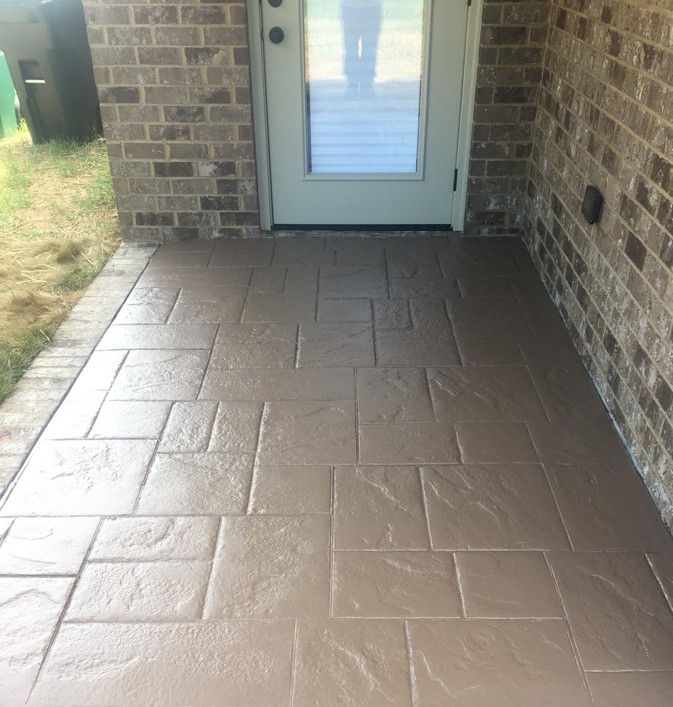 Small side yard patio in Other with stamped concrete.