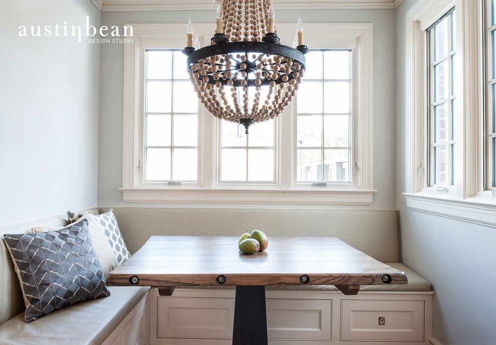Example of a transitional l-shaped medium tone wood floor eat-in kitchen design with a farmhouse sink, beaded inset cabinets, white cabinets, wood countertops, white backsplash, subway tile backsplash, stainless steel appliances, gray walls and an island