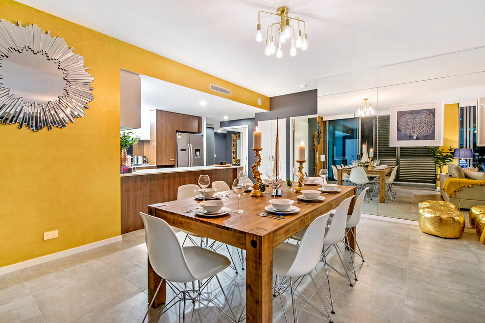 This is an example of a midcentury open plan dining in Gold Coast - Tweed with multi-coloured walls and grey floor.