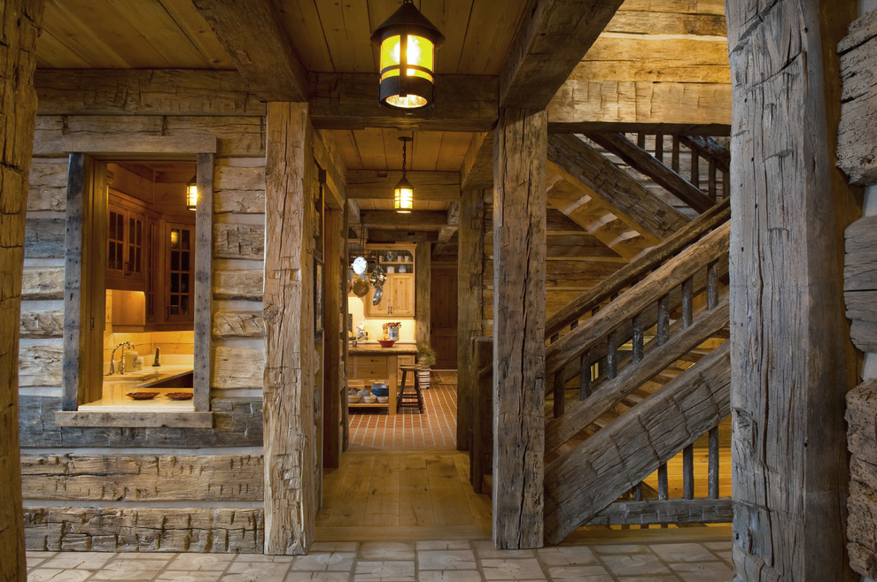 Photo of a country hallway in Minneapolis with light hardwood floors and brown walls.