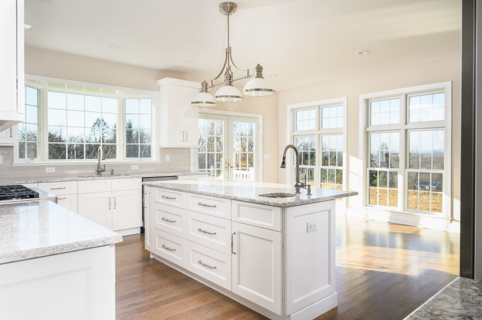 Klassische Küche mit weißen Schränken, Granit-Arbeitsplatte und Kücheninsel