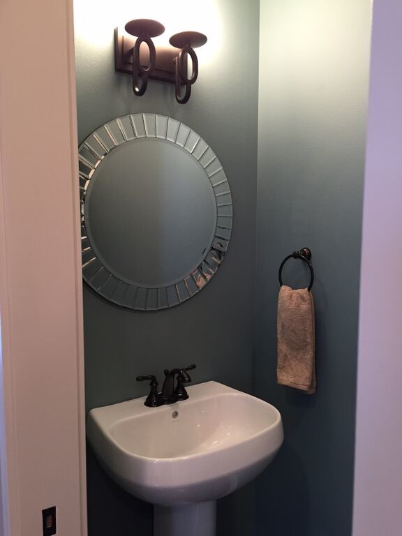 Example of a small transitional bathroom design with a pedestal sink and blue walls